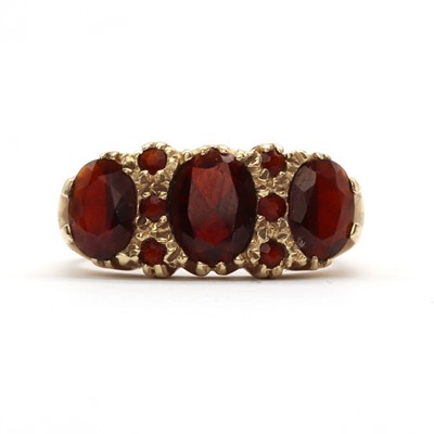 Lot 110 - A 9ct gold three stone garnet ring