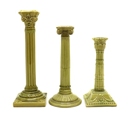 Lot 117 - Three Burmantofts green glazed candlesticks