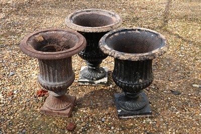 Lot 561 - A group of three Victorian cast iron garden Campana urns