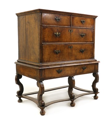 Lot 496 - A walnut chest on stand