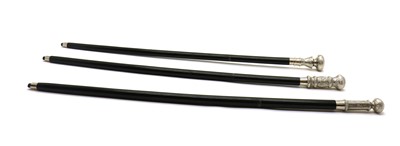 Lot 204 - Three ebonised walking canes