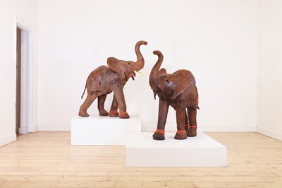 Lot 136 - A near pair of leather elephants