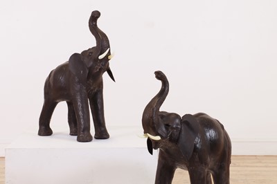 Lot 139 - A near pair of small leather elephants
