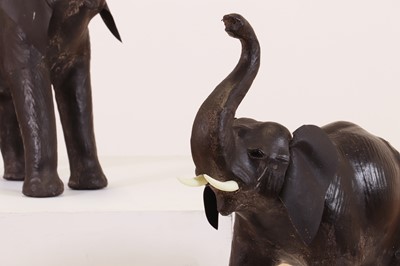 Lot 139 - A near pair of small leather elephants