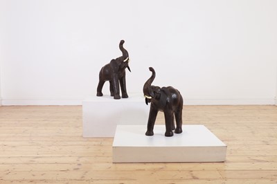 Lot 139 - A near pair of small leather elephants