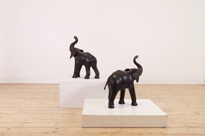 Lot 139 - A near pair of small leather elephants