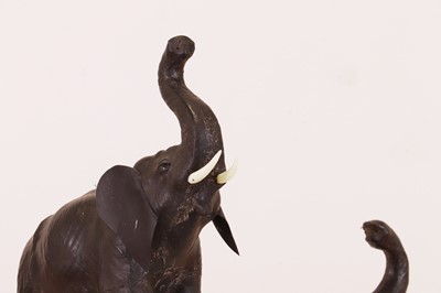 Lot 139 - A near pair of small leather elephants