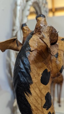 Lot 138 - A pair of painted hide figures of giraffes