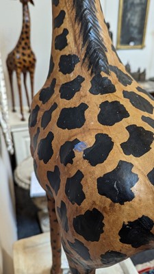 Lot 138 - A pair of painted hide figures of giraffes