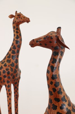 Lot 138 - A pair of painted hide figures of giraffes