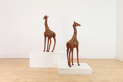 Lot 138 - A pair of painted hide figures of giraffes