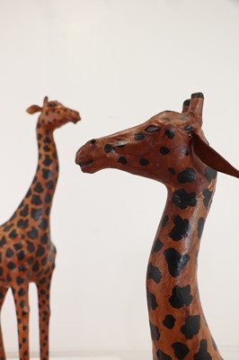 Lot 138 - A pair of painted hide figures of giraffes