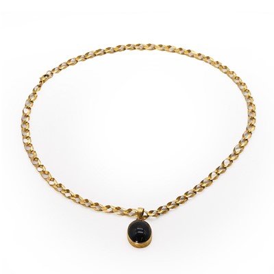 Lot 436 - An oval black paste pendant and chain