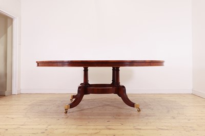Lot 297 - A Regency-style walnut extending dining table in the manner of Johnstone, Jupe & Co.