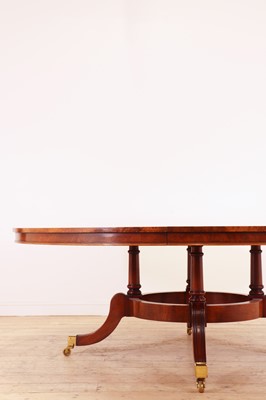 Lot 297 - A Regency-style walnut extending dining table in the manner of Johnstone, Jupe & Co.