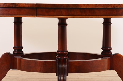 Lot 297 - A Regency-style walnut extending dining table in the manner of Johnstone, Jupe & Co.