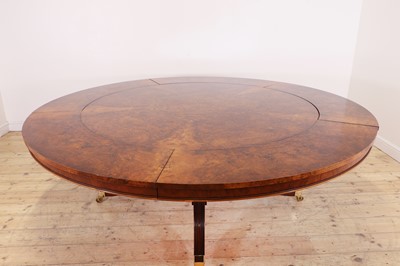 Lot 297 - A Regency-style walnut extending dining table in the manner of Johnstone, Jupe & Co.