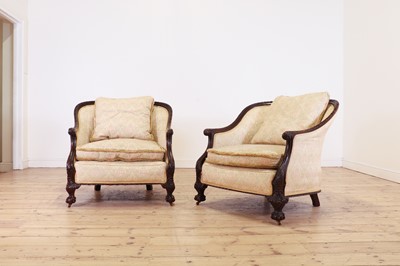 Lot 505 - A pair of large carved mahogany low bergère chairs