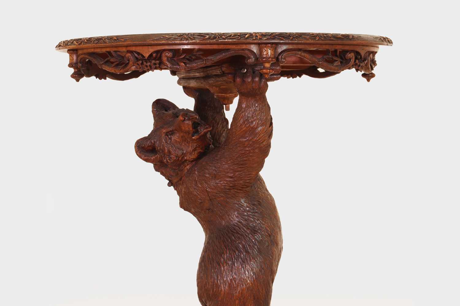 Lot 634 - A Black Forest carved wood occasional table