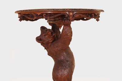 Lot 634 - A Black Forest carved wood occasional table