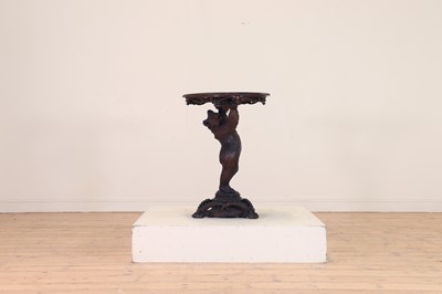 Lot 634 - A Black Forest carved wood occasional table