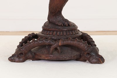 Lot 634 - A Black Forest carved wood occasional table
