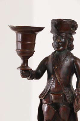 Lot 167 - A bronze figural candlestick