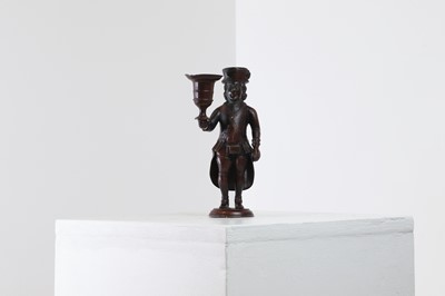 Lot 167 - A bronze figural candlestick