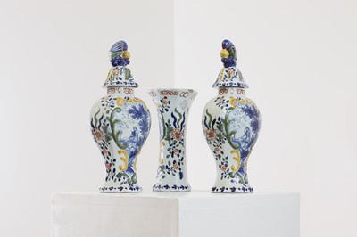 Lot 286 - A delft pottery polychrome part garniture