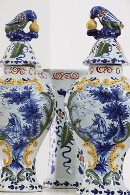 Lot 286 - A delft pottery polychrome part garniture