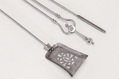 Lot 384 - A set of polished steel fire tools