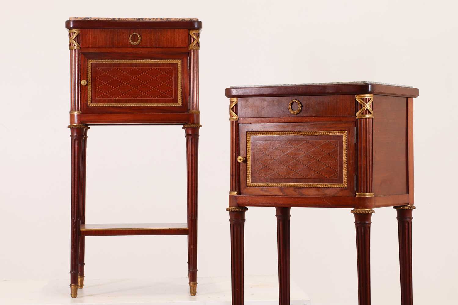 Lot 182 - A pair of Directoire-style mahogany tables de nuit