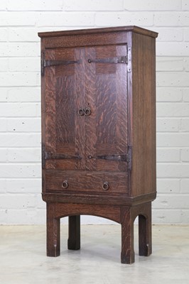 Lot 127 - A Liberty & Co. oak cupboard on stand
