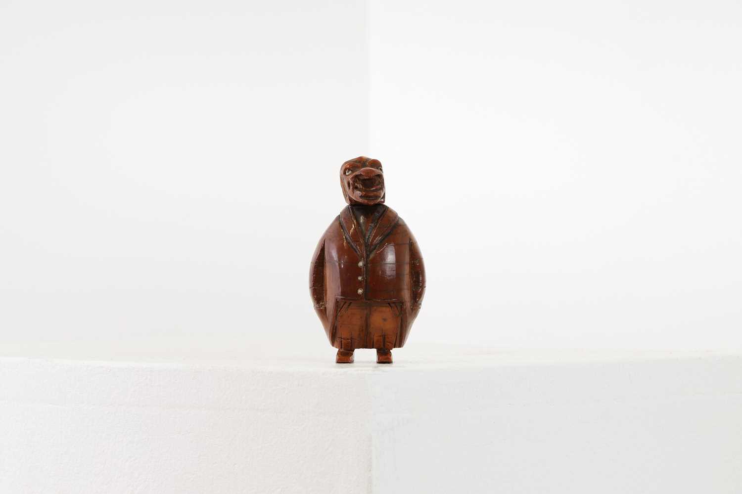 Lot 162 - A coquilla nut figural snuffbox