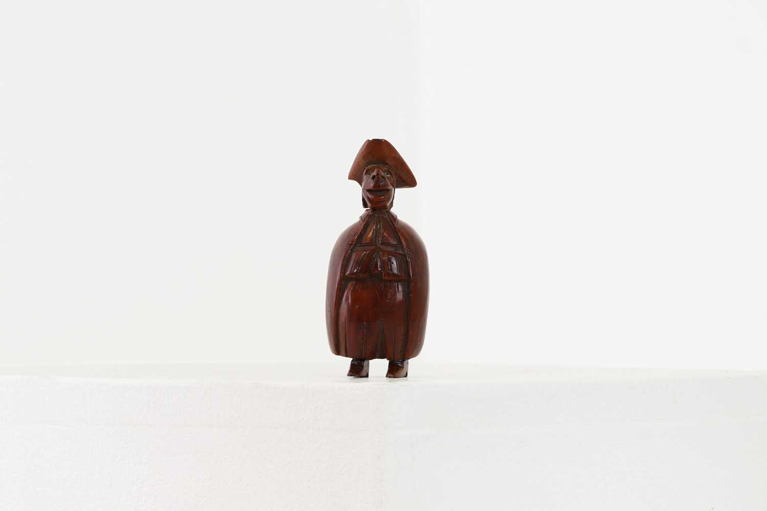 Lot 163 - A coquilla nut figural snuff box