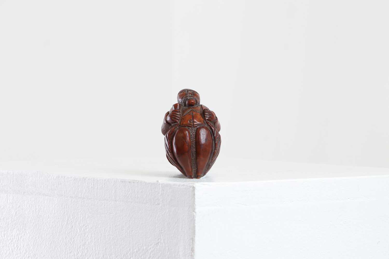 Lot 164 - A coquilla nut figural snuff box