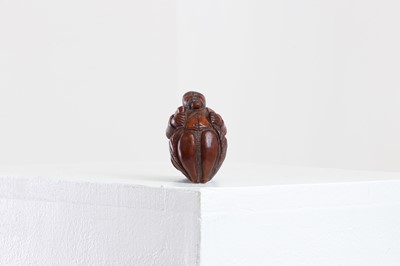 Lot 164 - A coquilla nut figural snuff box