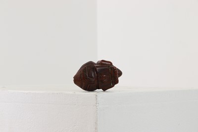 Lot 164 - A coquilla nut figural snuff box