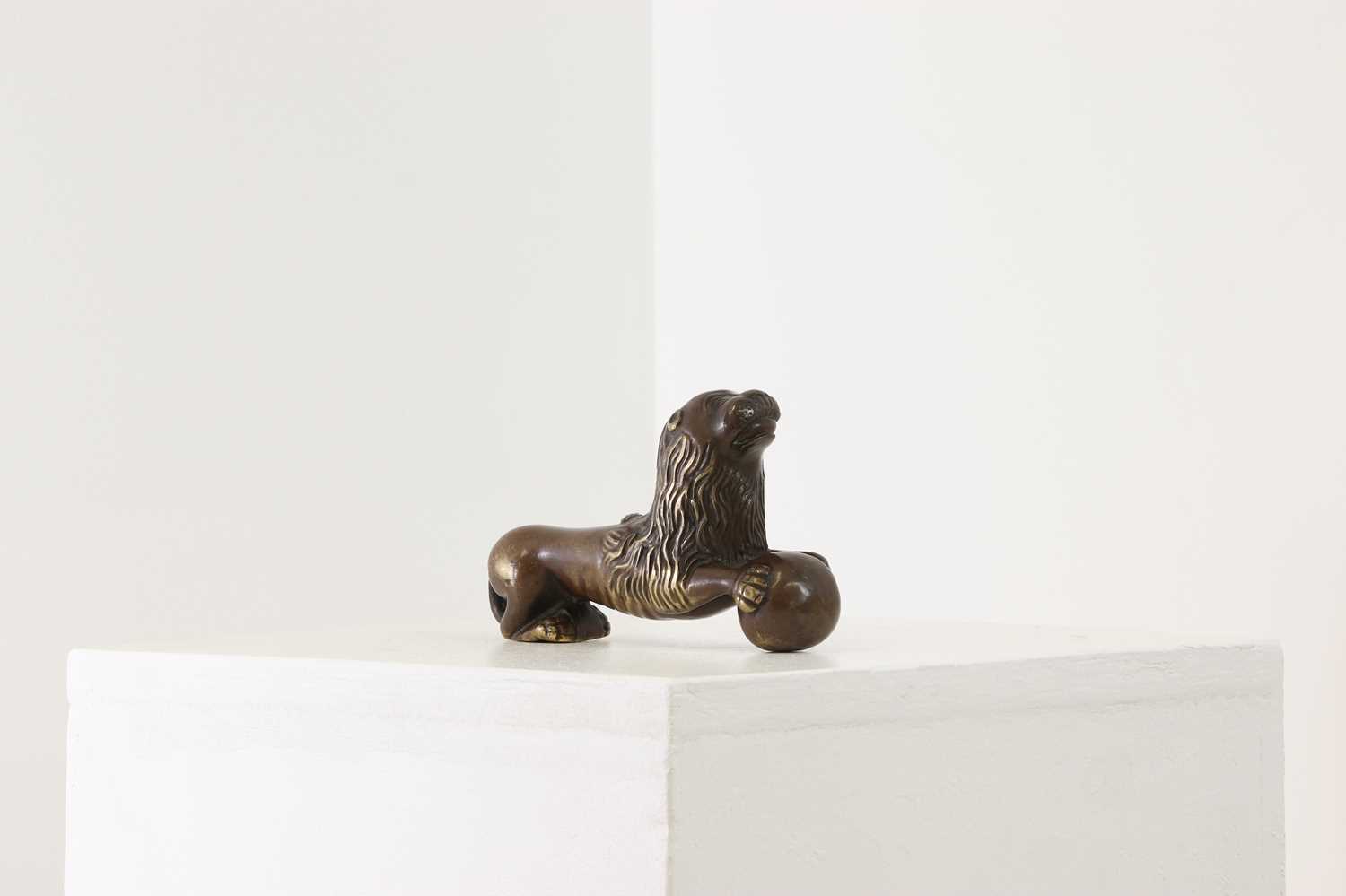 Lot 311 - A Romanesque-style bronze recumbent lion