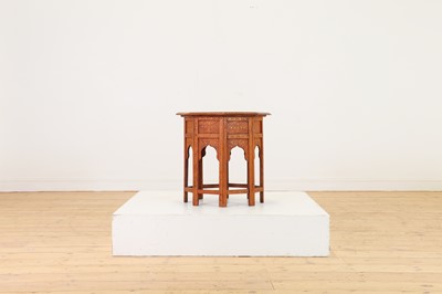 Lot 134 - A teak and brass octagonal occasional table
