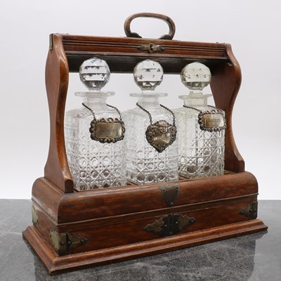 Lot 15 - An oak three bottle tantalus