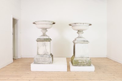 Lot 665 - A pair of painted cast iron urns