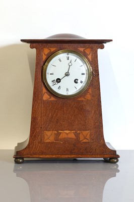Lot 115 - An Art Nouveau oak mantel clock