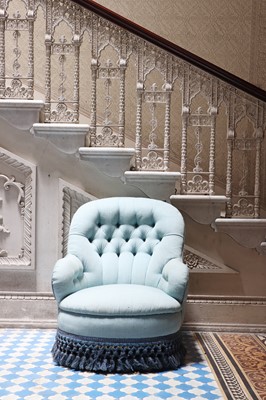 Lot 15 - A button-upholstered spoon-back armchair