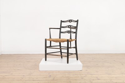 Lot 17 - An ebonised wooden elbow chair