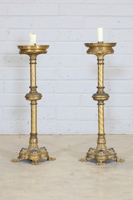 Lot 10 - A pair of tall brass candlesticks