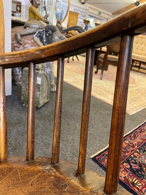 Lot 356 - A large ash and elm comb-back Windsor armchair