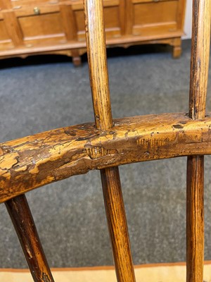 Lot 356 - A large ash and elm comb-back Windsor armchair