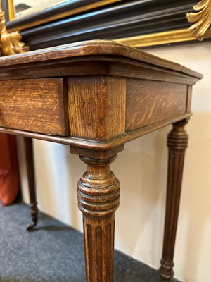 Lot 404 - An oak writing table by Holland & Sons