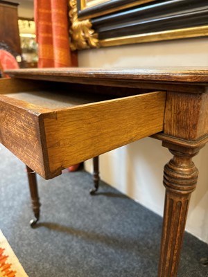 Lot 404 - An oak writing table by Holland & Sons